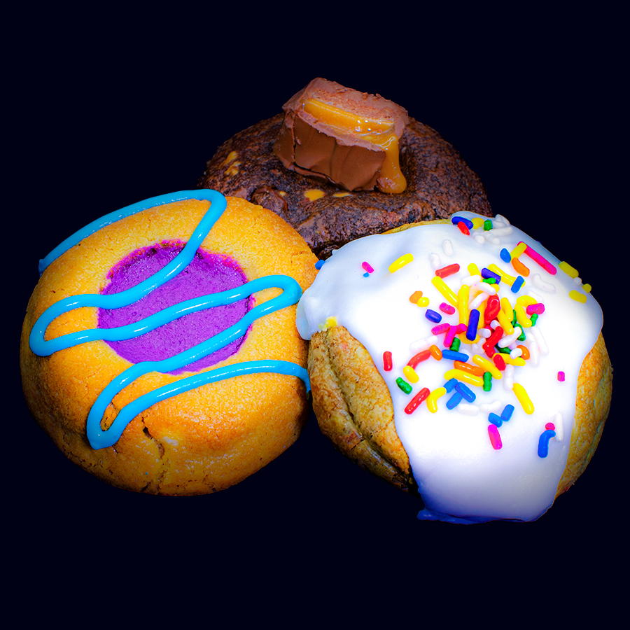 Three freshly baked cookies grouped together, including a s'mores Fatty, Fruity Pebbles Fatty, and Cookie Dough Bite Fatty 